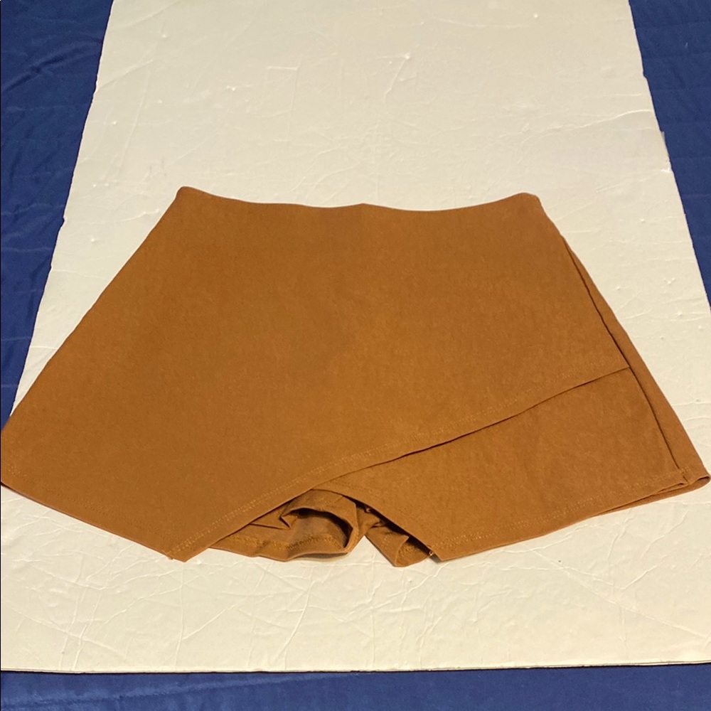 NWT Skort made by Blue Blush. The color is called Desert orange.  Zips in back.